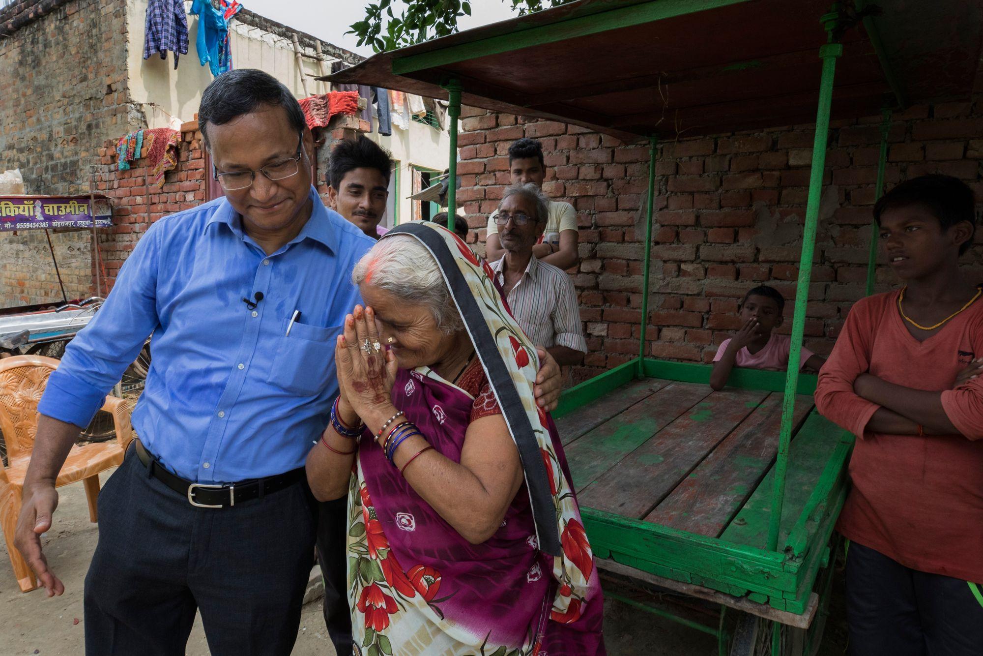 Govind Singh (left), chief executive officer of Utkarsh Small Finance Bank, greets Irawati Devi and her family at their home in Harhua Village, on September 20, 2018. Irawati is small-business owner who has taken several microfinance loans from Utkarsh. Photo © Dominic Chavez / International Finance Corporation                      
