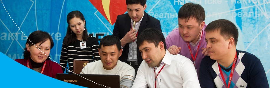 A group of people looking at a computer