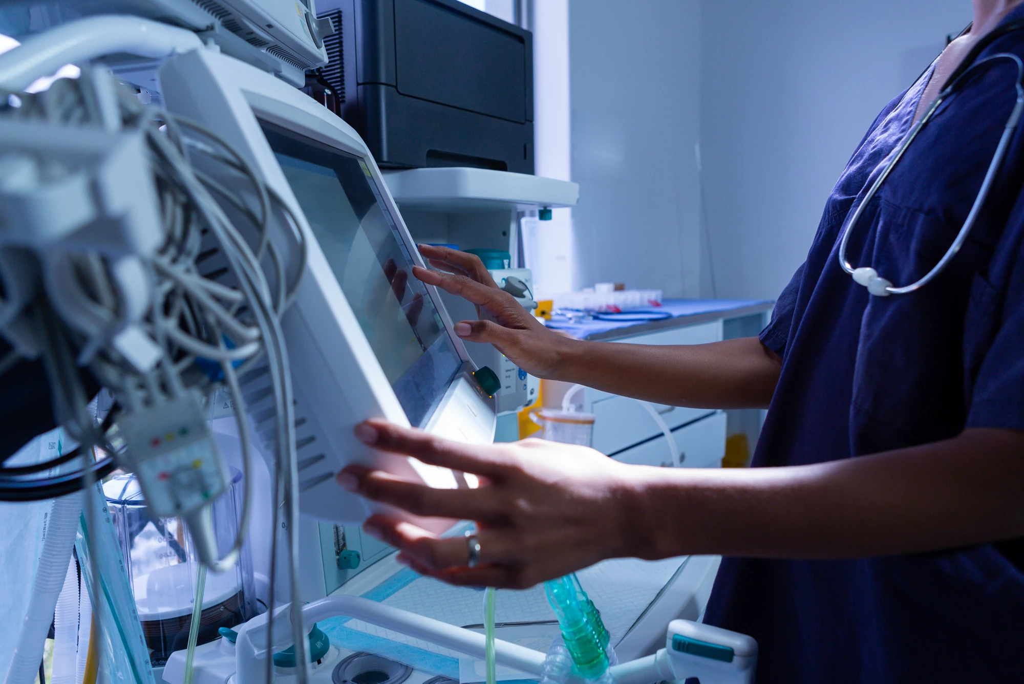 A medical worker checking a medical device.