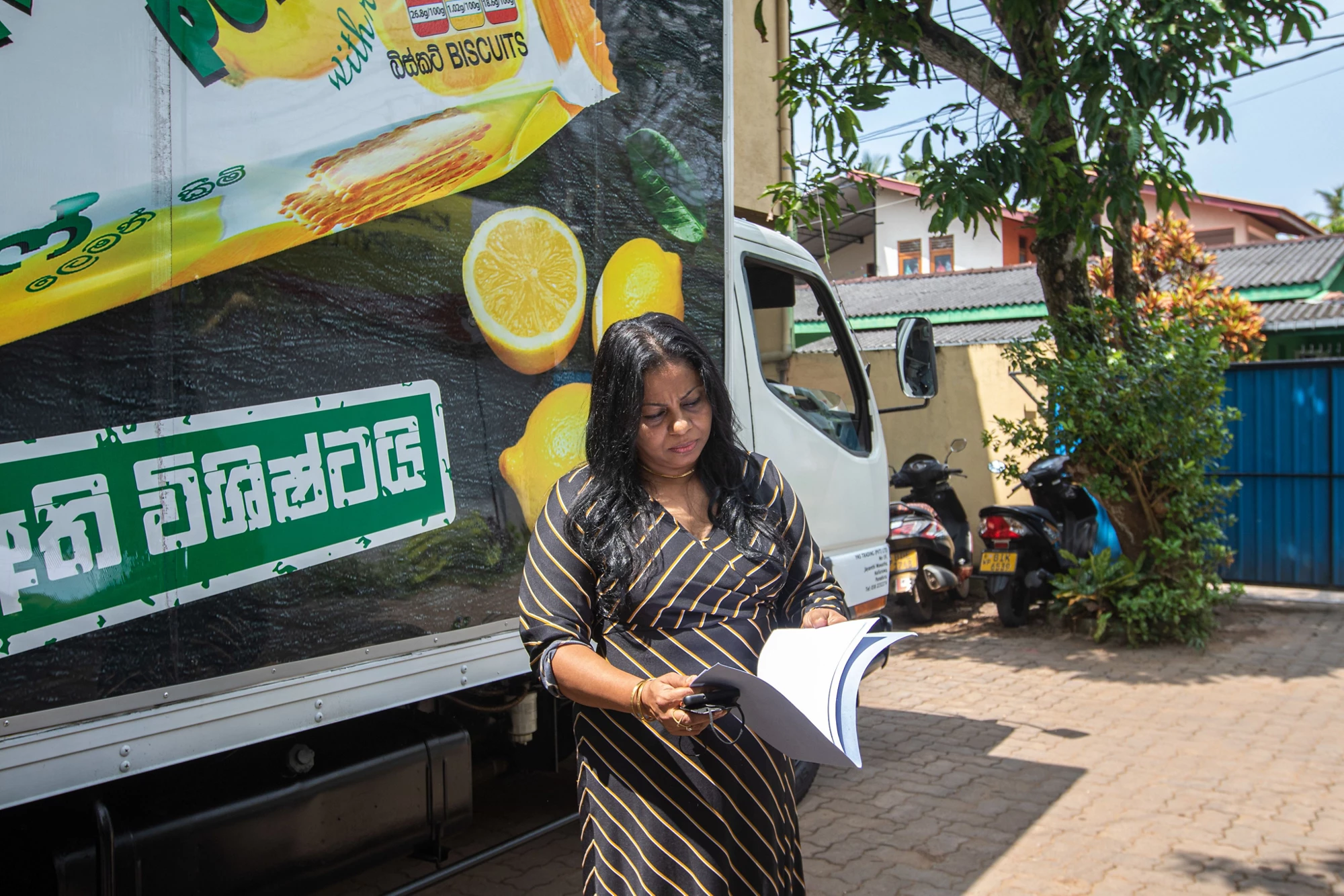 A woman executive in Sri Lanka reviews materials for her distribution company.